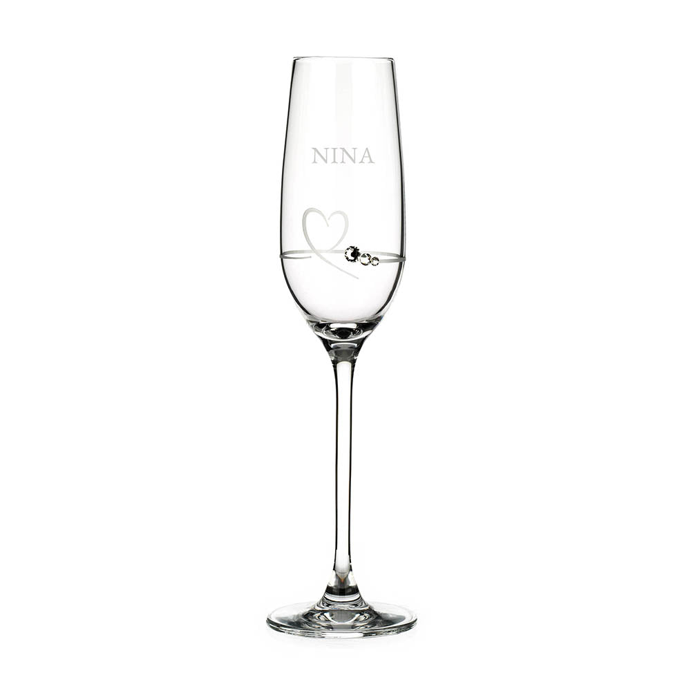 Clear glass flute with 'NINA' engraved on a white background