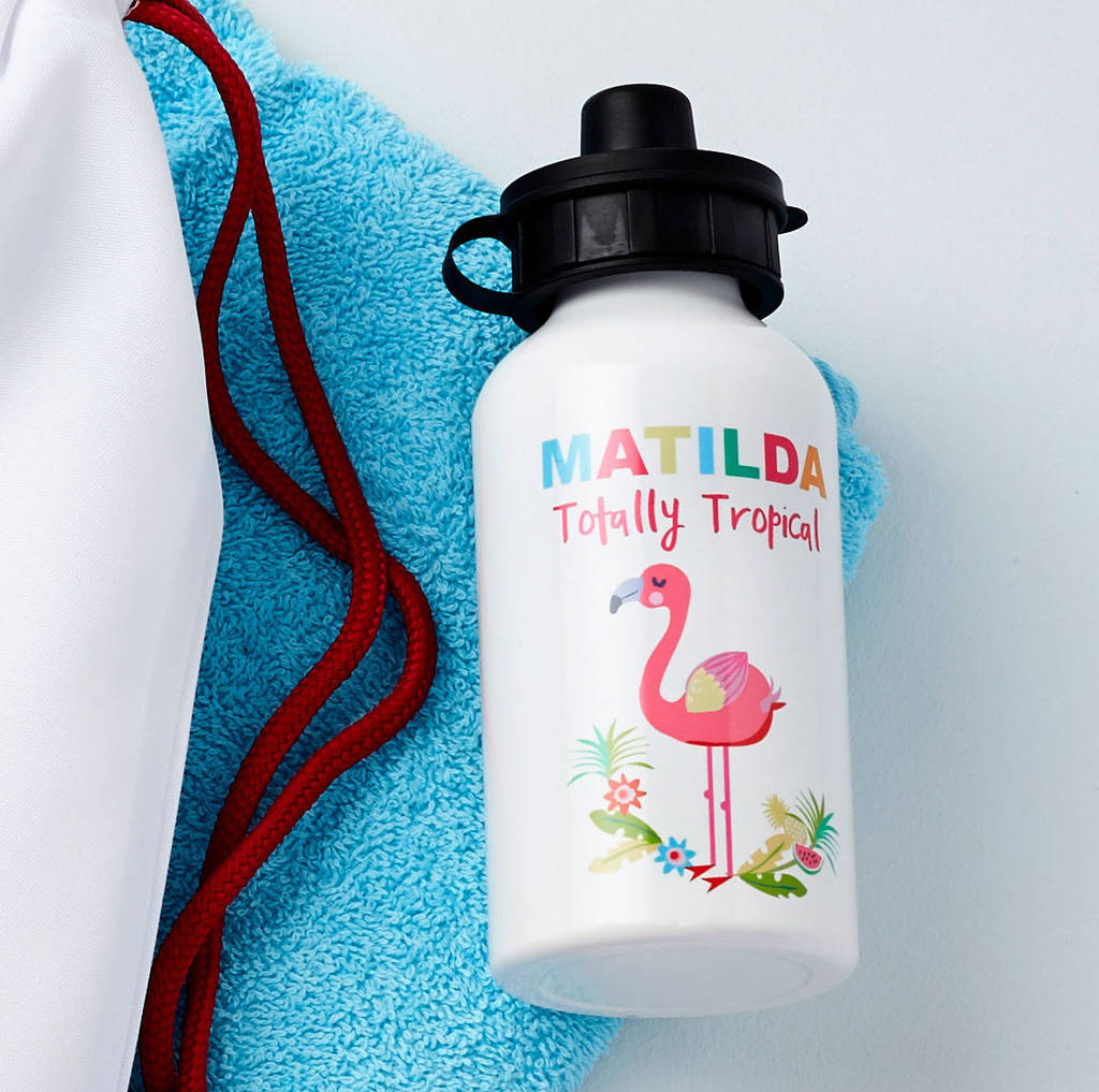 White water bottle with colorful flamingo design and text on a blue towel