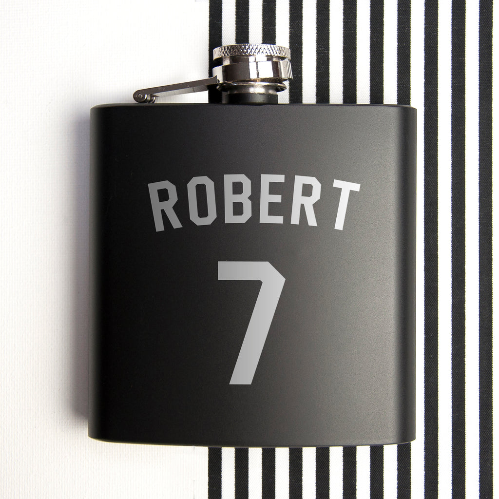 Black flask with 'ROBERT' and number '7' on a black and white striped background