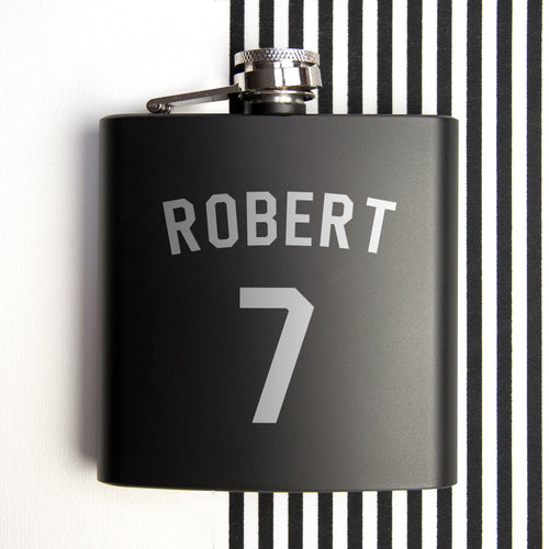 Black flask with 'ROBERT' and number '7' on a black and white striped background