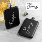 Two black flasks with 'Fraser' and 'James' engraved on them, placed on a light gray surface.