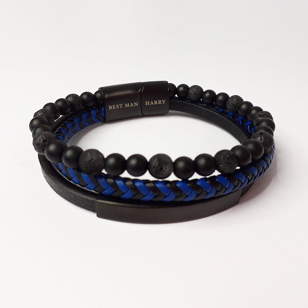 Black beaded bracelet with blue braided section on a white background