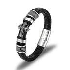 Black braided leather bracelet with silver cross charm on a white background