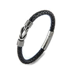Black braided leather bracelet with silver metal accents on a white background