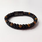 Black and brown beaded bracelet with a black clasp on a white background
