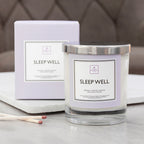 Sleep Well candle and packaging on a surface with a neutral background
