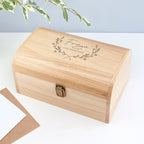 Wooden box with engraved name on a light background