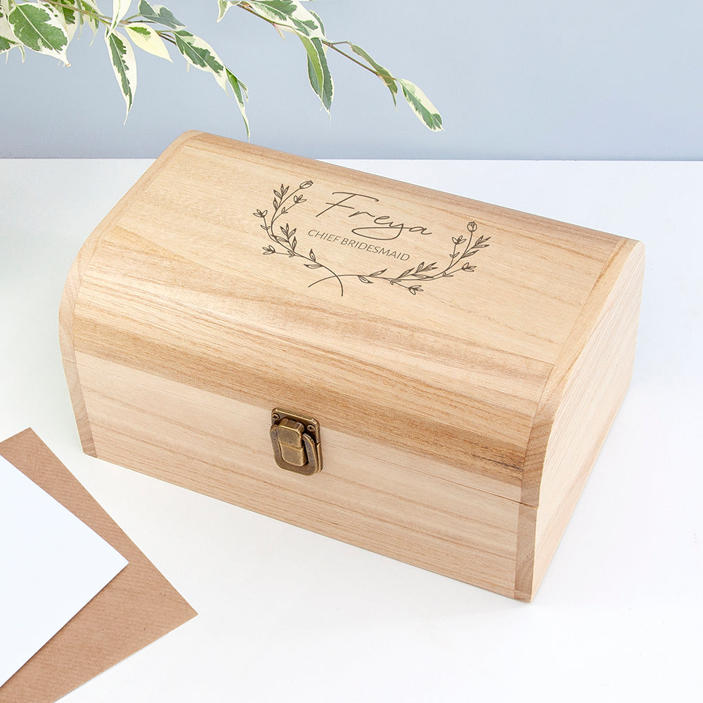Wooden box with engraved name on a light background