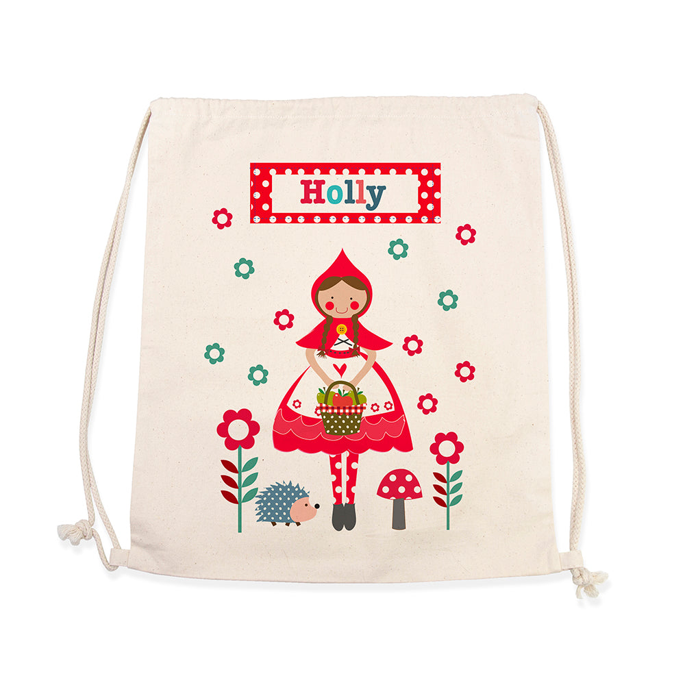 Drawstring bag with a cartoon character of a girl in a red dress and hat, surrounded by flowers and mushrooms, with 'Holly' printed on a label.