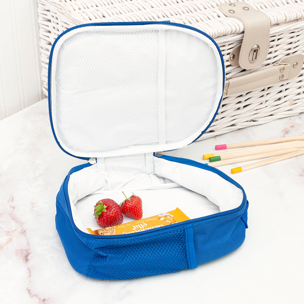 Blue insulated lunch bag with strawberries and snacks on a white surface