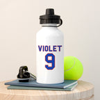White water bottle with 'VIOLET 9' printed on it, next to a tennis ball on a wooden surface.
