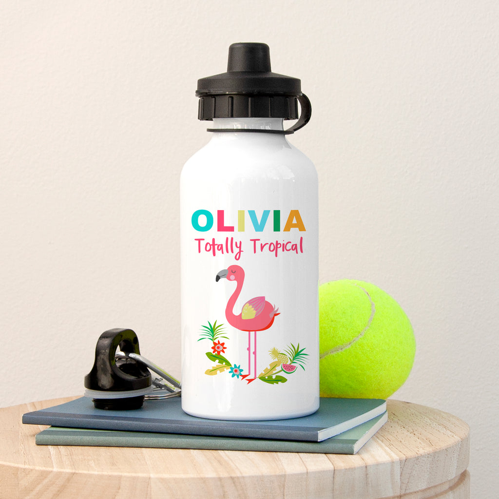 Personalized water bottle with flamingo design and text, placed on a wooden surface with a tennis ball and keys.