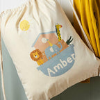 Drawstring bag with animal illustrations and the name 'Amber' on a light background